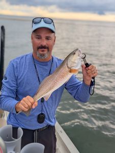 A fisherman catching a 12-inch fish in Florida