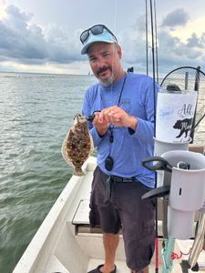 A fisherman holds a summer flounder in Florida