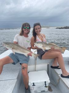 Two redfish caught during fishing trip in Orange Beach