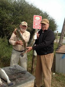 Two anglers fishing in Florida with two fish