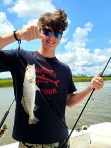 A 12-inch spotted weakfish caught while fishing in SC