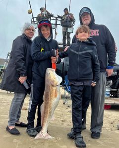 A group of 5 people on the Bolivar Peninsula, enjoying a fishing trip