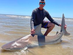 Angler holding a 57-inch fish on Bolivar Peninsula