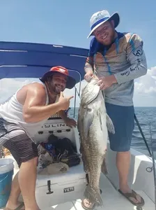 Anglers posing with a big fish catch in Florida