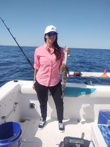 A lone fisherman in FL reeling in a catch