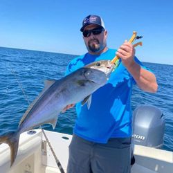 A fisherman in Florida holding a 24-inch catch