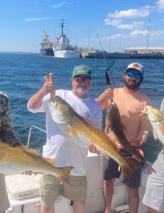 Two people fishing in Florida with two big fish