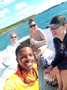 Four people enjoying a fishing trip in Nassau