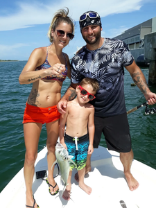 4 people enjoying a day of fishing and water sports at Pensacola Beach