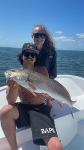 Two people fishing with a rod in Tampa