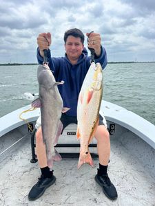 Two freshly caught fish displayed on boat deck - blue catfish and redfish from Elmendorf TX fishing trip