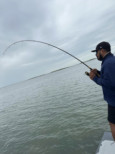 A lone angler fishing on the coast of Port Mansfield