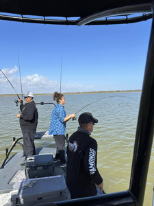 Three people fishing at Port Mansfield