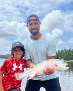 A pair of anglers fishing for a rainbow trout in NY
