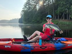 Angler with a largemouth bass caught in NY