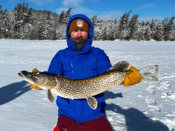 Northern pike caught ice fishing in Paul Smiths NY winter landscape