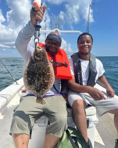 Angler holding a southern flounder fish in North Carolina