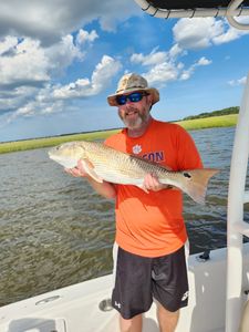 Angler catching a large redfish in GA
