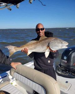 Lone fisherman catching a 35-inch fish in Brunswick
