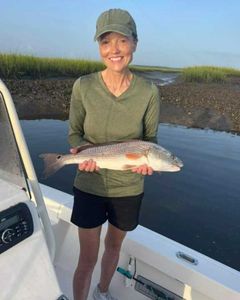 A lone fisherman catching a great 18-inch fish in Brunswick