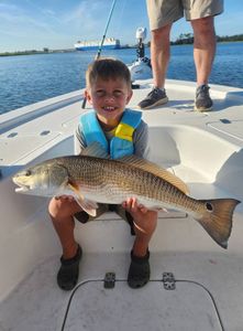 Angler reeling in a redfish in GA