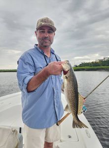 A fisherman catches a spotted weakfish in Brunswick.