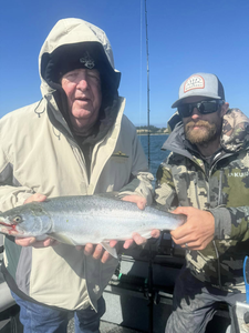 Angler catching a rainbow trout in Oregon