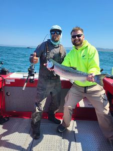 A pair of anglers fishing for a rainbow trout in Myrtle Creek