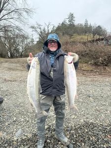 A person fishing with two fish in Oregon