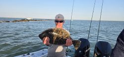 Angler with a large Southern Flounder fish caught in Galveston
