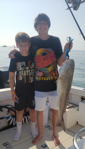 2 people fishing in Galveston with a 28-inch catch