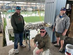 Three people enjoying a fishing trip in Galveston