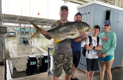 Four people fishing with a big fish caught in TX