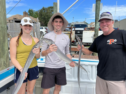3 people fishing in the water at Virginia Beach