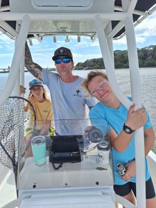 Three people enjoying a fishing trip in St. Augustine