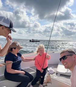 Fishing trip on boat in Gulf Shores AL with fishing rod and ocean view