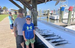 King mackerel fishing catch displayed on dock cleaning table in Gulf Shores AL