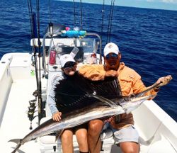 Two people fishing for an Atlantic Sailfish in Tavernier