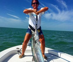 A fisherman holding a King Mackerel in Tavernier