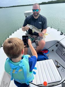 An angler with a 14-inch fish in Naples.