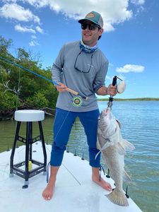 A person fishing with a rod, located in FL