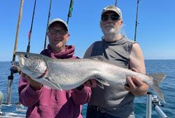 Two people fishing in Duluth with a 36-inch fish