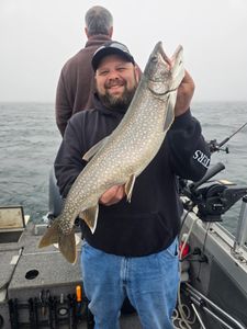 A lone angler fishing in Minnesota, with a lake trout catch