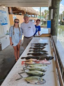 Fishing charter catch display with blue runners and other fish species on cleaning table in Port Orange FL