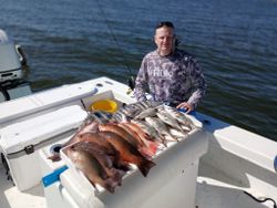 Successful fishing trip in Port Orange FL with mixed catch of fish displayed on boat deck