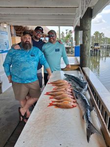 Fishing charter catch display featuring lane snapper and great barracuda at Port Orange FL marina
