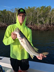 Angler holding a snook catch during fishing charter in Port Orange FL