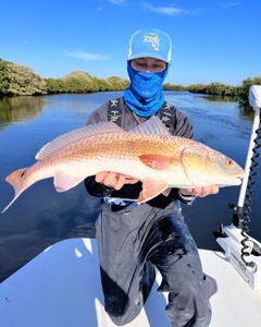 Fisherman holding a 24-inch fish in FL