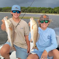 Two redfish measuring 20 inches, caught while fishing in FL