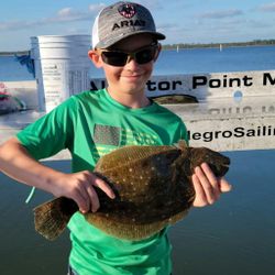 A person holding a summer flounder fishing in Panacea